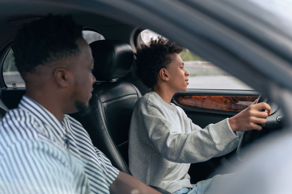 Teenager driving a car with a parent in the passenger seat